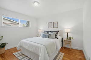 Primary Bedroom featuring baseboards and light wood finished floors