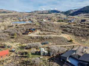 Aerial view of property's location with a water and mountain view