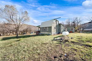 View of side of property with a lawn