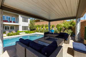 Outdoor pool with a patio, outdoor furniture, and a fenced backyard