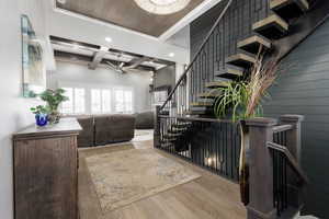 Stairs featuring wood finished floors, recessed lighting, a ceiling fan, and coffered ceiling
