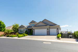 Craftsman inspired home with an attached garage, stucco siding, driveway, and stone siding