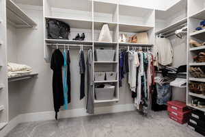 Walk in closet with light carpet