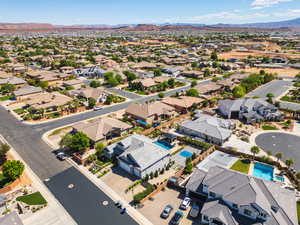 Aerial view of property's location with a mountainous background and nearby suburban area