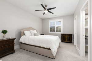 Bedroom featuring light carpet and ceiling fan