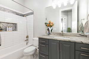 Bathroom with vanity, shower / washtub combination, and tile patterned floors