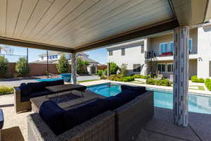 View of swimming pool featuring patio surround, a storage shed, and outdoor seating