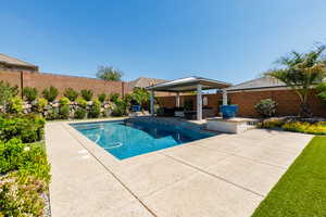 View of swimming pool featuring a fenced backyard, patio surround, an outdoor living space, and a gazebo