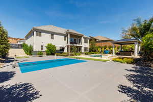 Outdoor pool with a patio and a gazebo