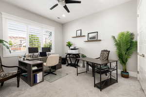 Home office with light colored carpet, ceiling fan, and recessed lighting