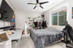 Bedroom with light carpet and ceiling fan