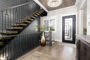 Foyer entrance featuring light wood-type flooring and stairs