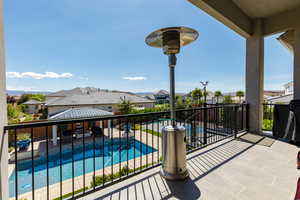 Balcony with view of pool area and a residential view