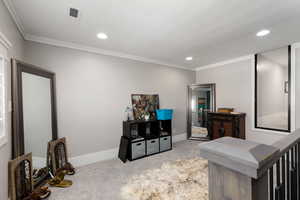 Sitting room featuring light carpet, recessed lighting, and ornamental molding