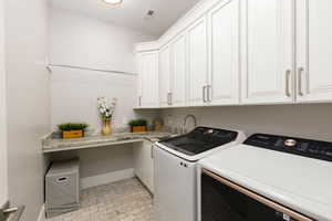 Laundry room featuring washer and dryer and cabinet space