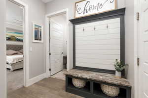 Mudroom with wood finished floors and baseboards