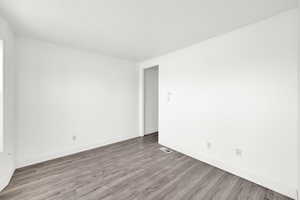 Unfurnished room featuring light wood finished floors and baseboards