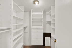 Walk in closet with dark tile patterned flooring