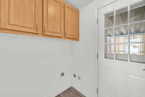 Laundry room featuring cabinet space, dark wood-style flooring, hookup for an electric dryer, and a textured ceiling