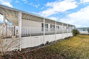 View of side of home with a yard