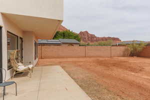 Fenced backyard featuring a patio area and a mountain view