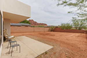 Fenced backyard featuring a patio