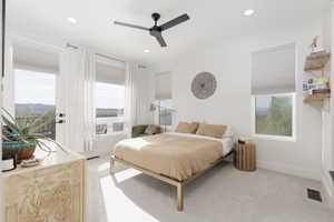 Bedroom with carpet, multiple windows, a ceiling fan, access to outside, and recessed lighting