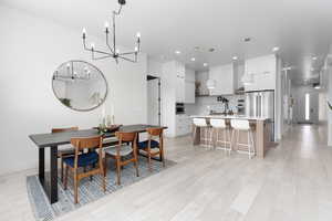 Dining room featuring suspended lighting and light wood finished floors