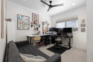 Office space featuring light carpet, a ceiling fan, and recessed lighting