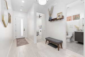 Foyer with light wood-style floors and recessed lighting