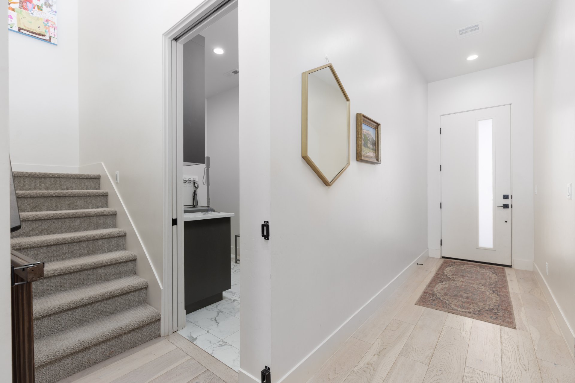 Entrance foyer with light wood-style flooring and recessed lighting