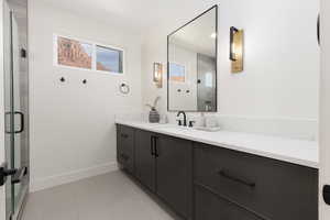 Bathroom featuring vanity, a stall shower, and light tile patterned flooring