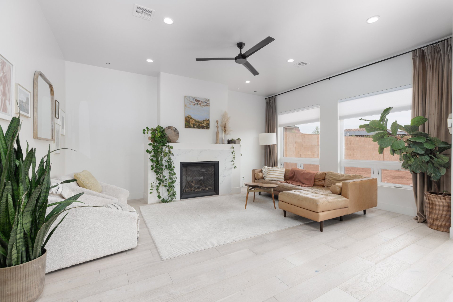 Living room with ceiling fan, recessed lighting, light wood-style flooring, and a fireplace