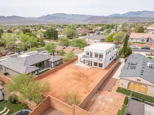 Aerial perspective of suburban area featuring a mountainous background