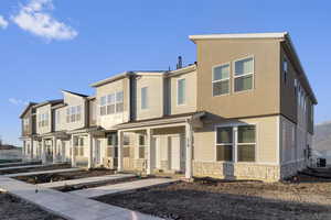 View of front of property with a porch and stone siding