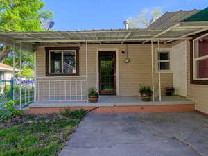 View of exterior entry with a porch