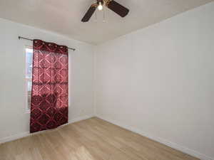 Unfurnished room featuring light wood-style flooring and ceiling fan
