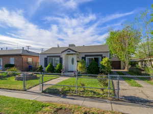 View of front of home featuring a fenced front yard and a gate