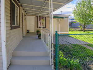 Doorway to property with covered porch
