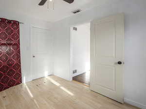 Unfurnished bedroom with light wood-type flooring and ceiling fan