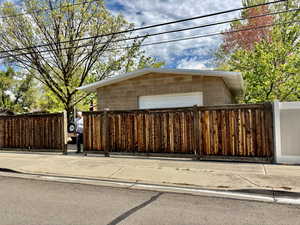 Fully Fenced with entrance to the Brick Shop Garage door entry