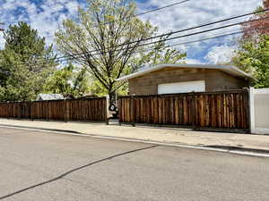 Fully Fenced with entrance to the Brick Shop Garage door entry