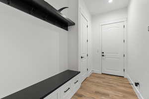 Mudroom featuring light wood-style floors and recessed lighting