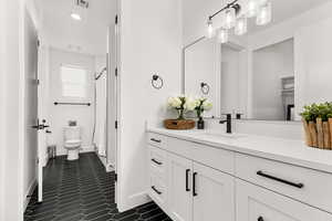 Full bath with vanity, a shower with curtain, dark tile patterned floors, and recessed lighting