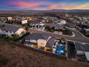 Aerial view of residential area with a pool area and a mountainous background