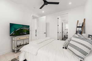 Bedroom featuring a ceiling fan, recessed lighting, and connected bathroom