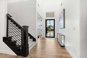 Foyer with a high ceiling and light wood-type flooring