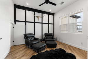 Living area featuring ceiling fan, light wood finished floors, and recessed lighting
