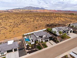 Aerial perspective of suburban area with a mountainous background and a pool area
