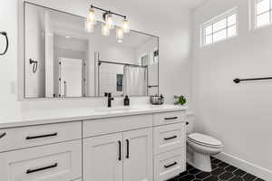 Full bathroom with vanity and a shower with shower curtain